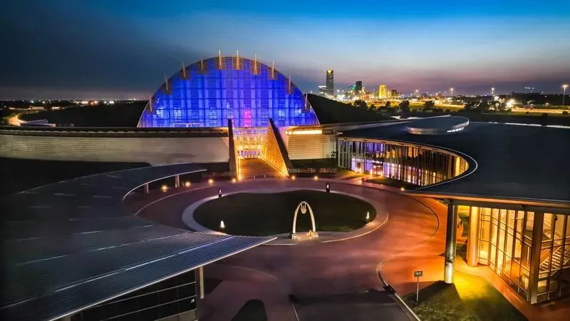 First Americans Museum Oklahoma City United States illuminated glass dome at night with purple and gold lighting