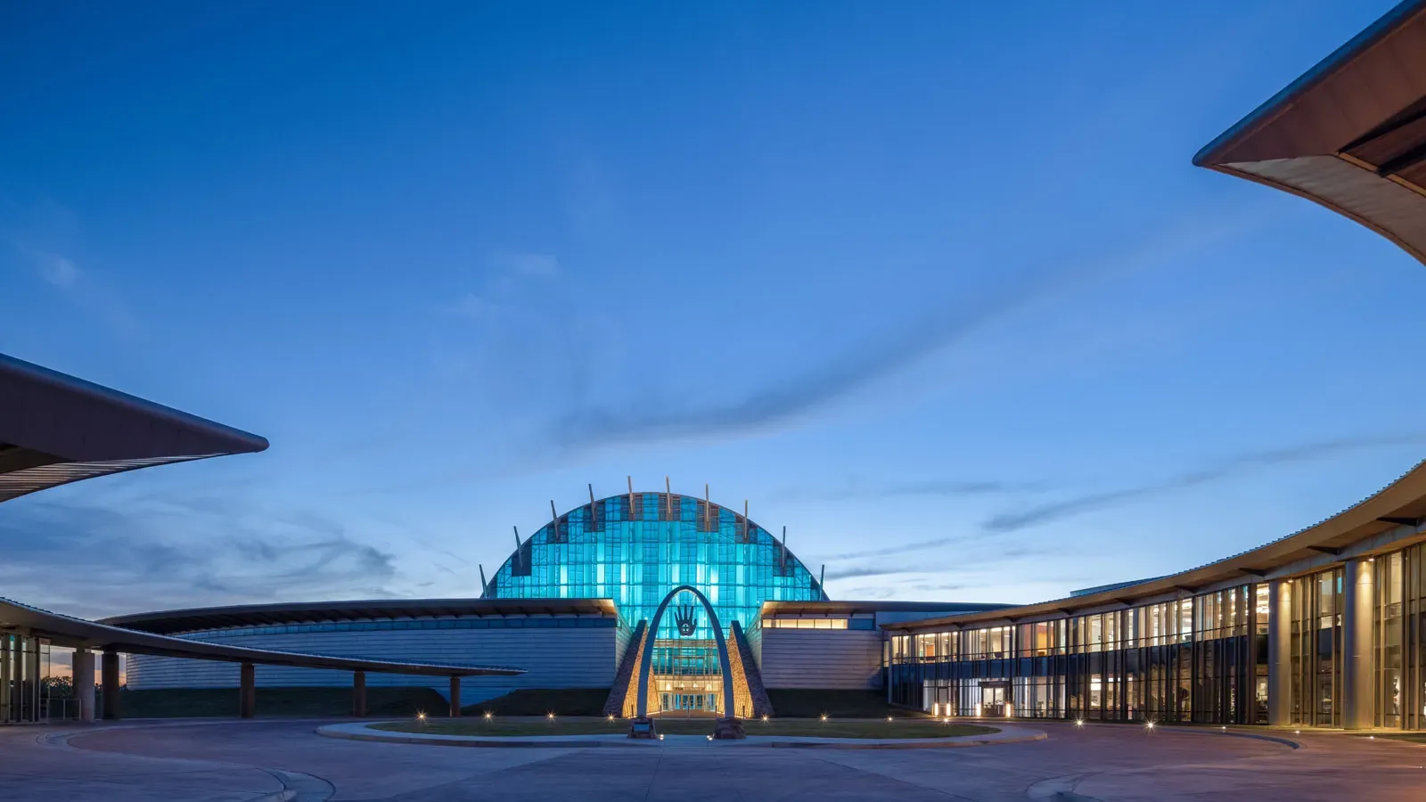 First Americans Museum Oklahoma City United States modern curved architecture with blue accent lighting at twilight