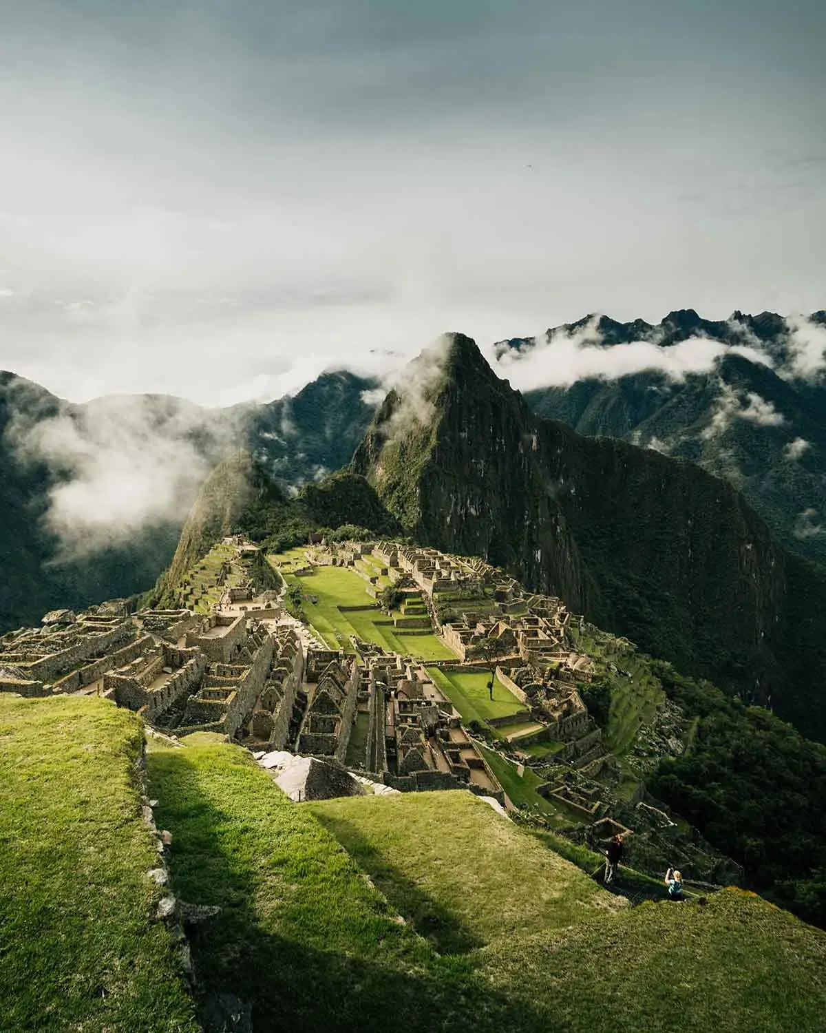 Machu Picchu, Peru set among misty green mountains with Huayna Picchu peak