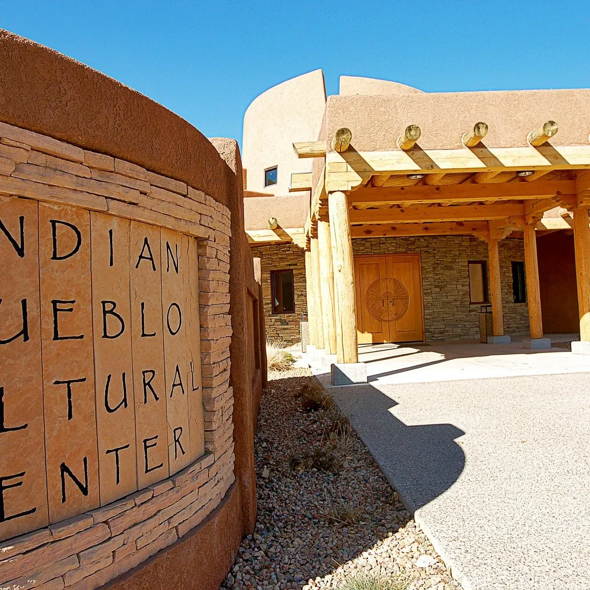 Main entrance of the Indian Pueblo Cultural Center Albuquerque with traditional Pueblo-style wooden door and architecture