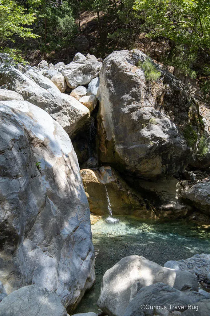 Small waterfall and flowing creek along the Samaria Gorge hiking trail