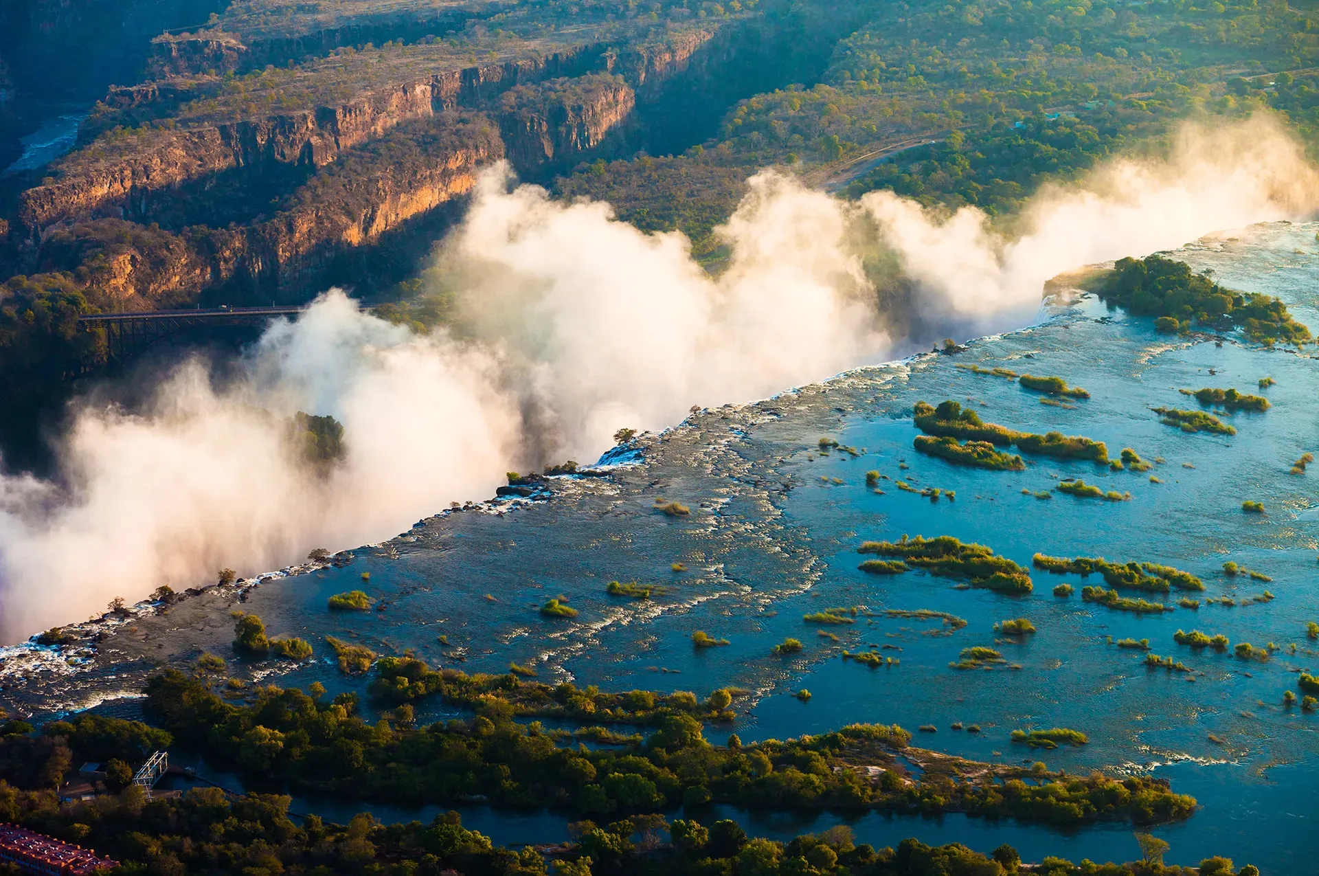 Aerial view of Victoria Falls Zimbabwe showing the massive curtain of water cascading into the Zambezi River