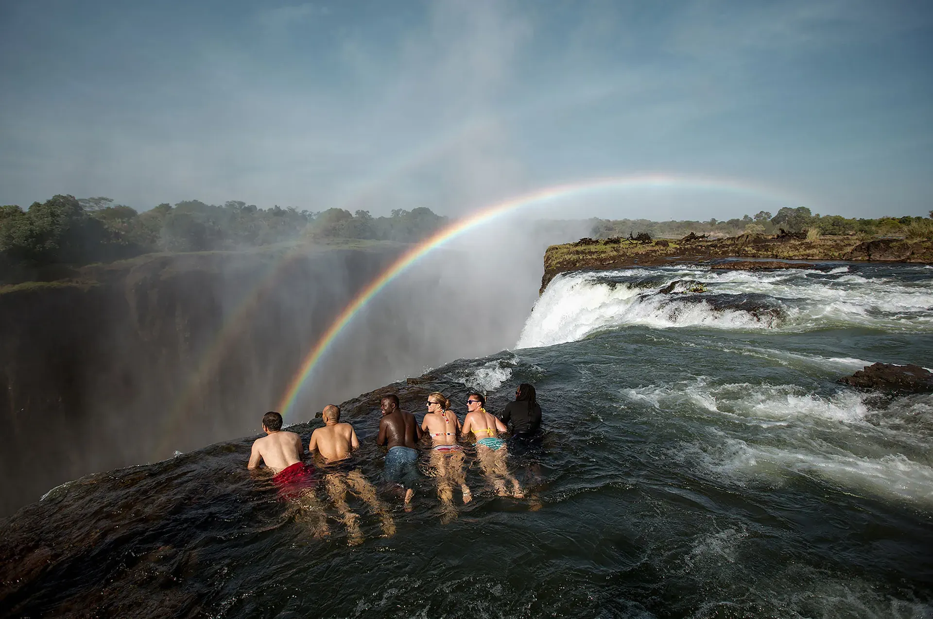 Thrill-seekers at Devil's Pool on the edge of Victoria Falls Zimbabwe