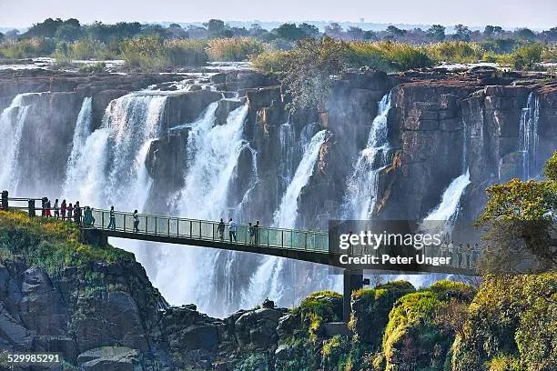 Tourists crossing the Knife-Edge Bridge at Victoria Falls Zimbabwe