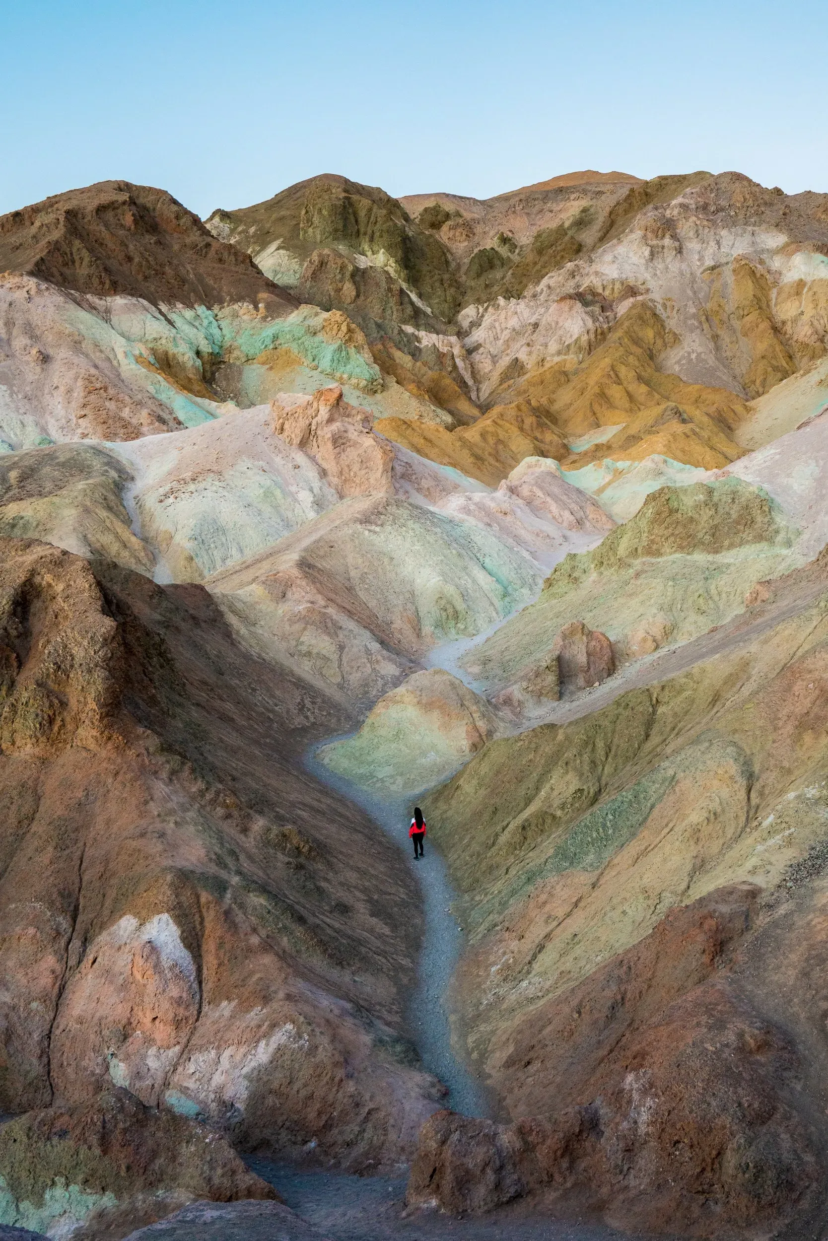 Hiker at colorful rock formations