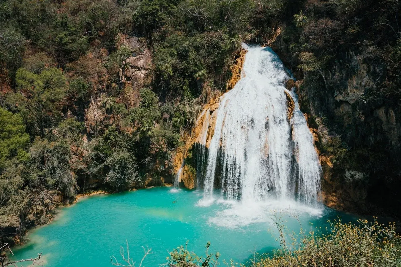 Cascada Quinceañera waterfall cascading over rocky cliffs into vibrant turquoise pool