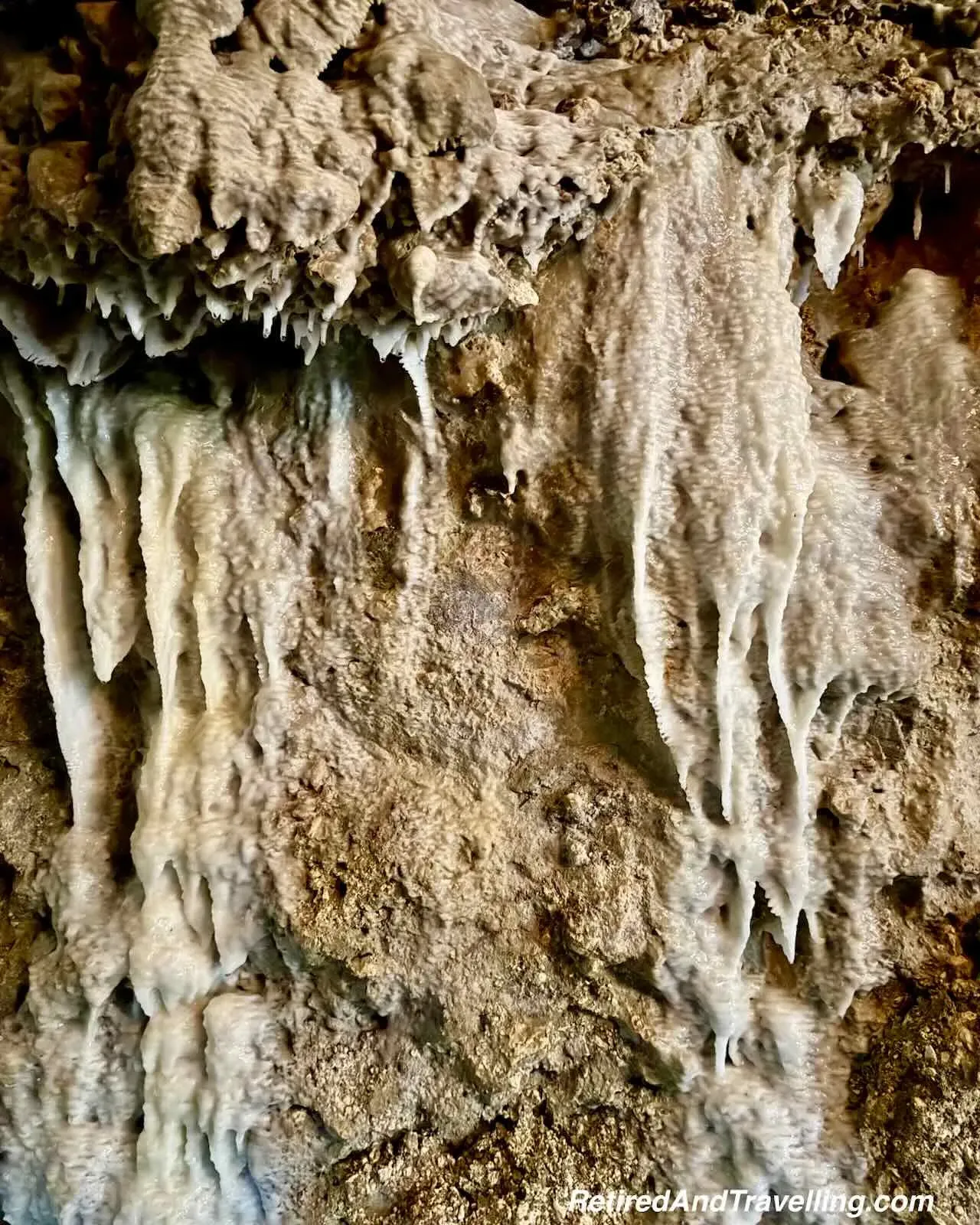 Detailed mineral formations and flowstone on cave walls