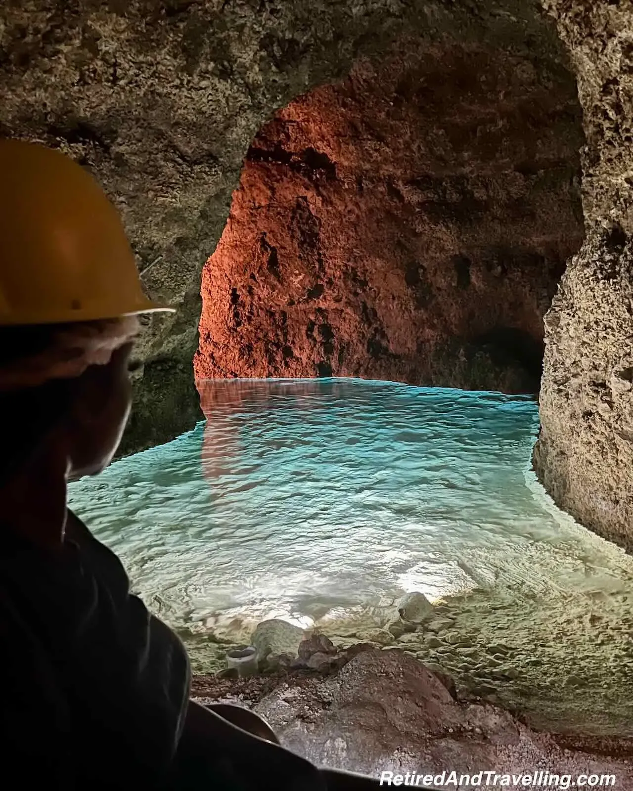 Crystal clear emerald green pool surrounded by limestone
