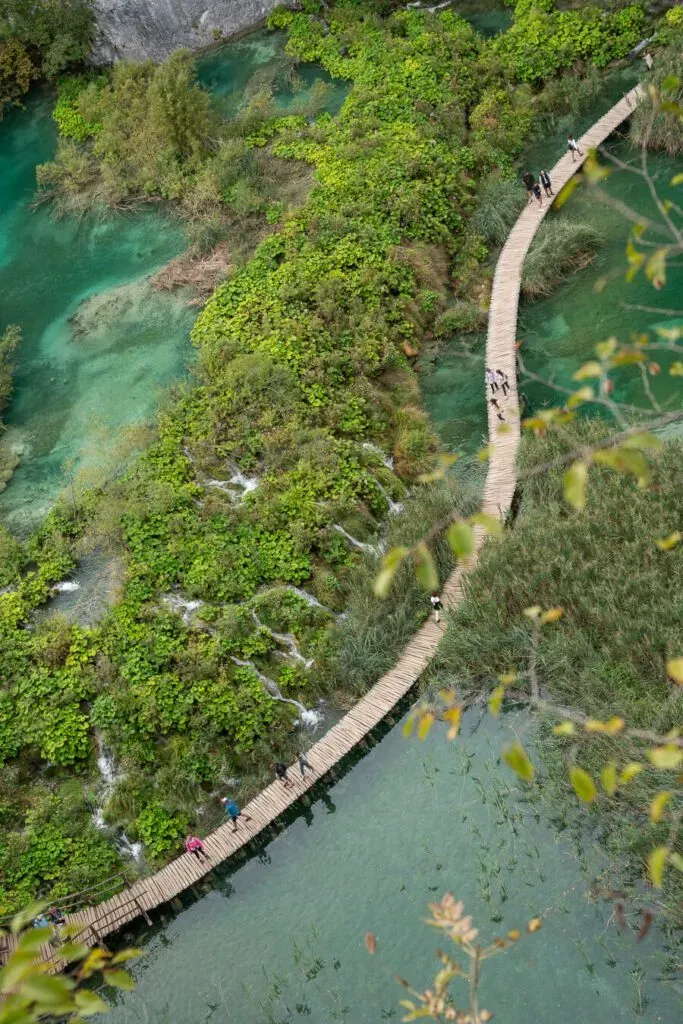Curving wooden walkway over turquoise waters