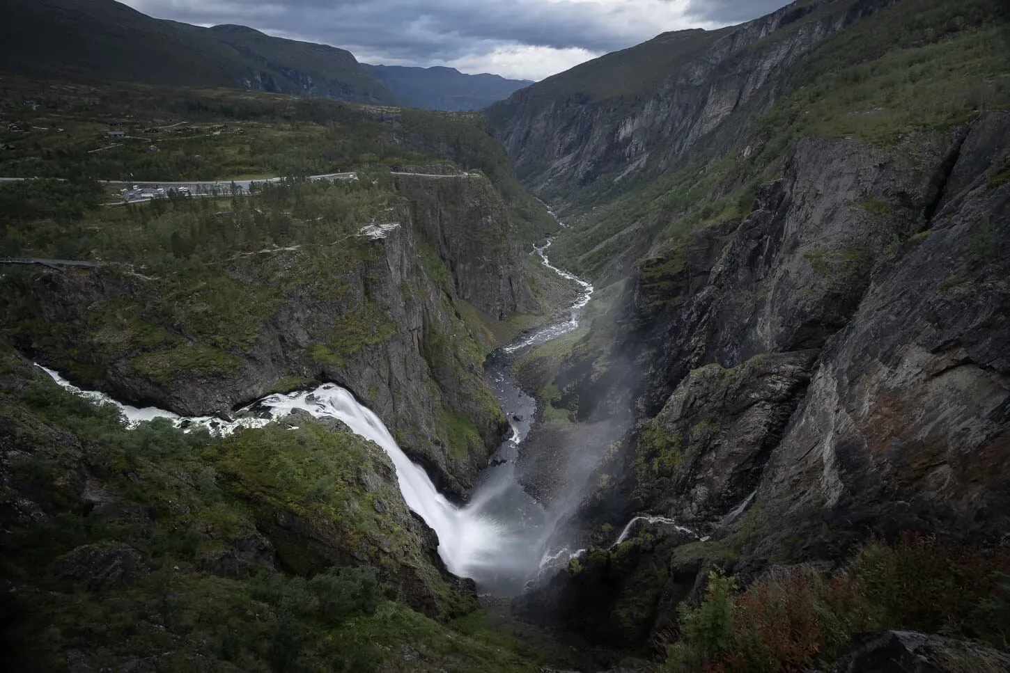 Vøringsfossen waterfall cascading down steep cliffs into lush green gorge