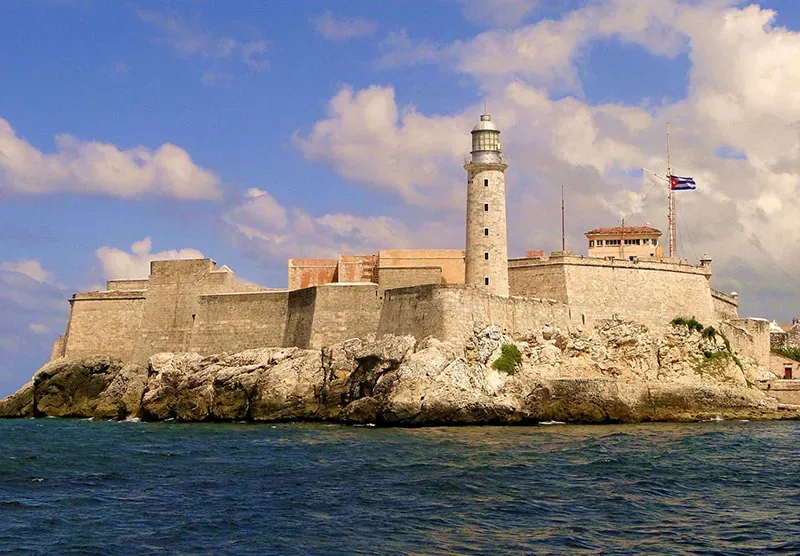 Historic Morro Castle fortress with lighthouse and Cuban flag on the Havana Cuba coastline