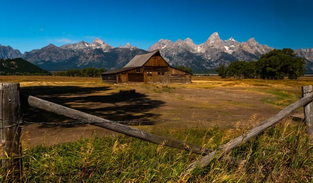 Historic Moulton Barn on Mormon Row with snow-capped Grand Teton peaks