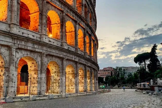 Illuminated Colosseum at dusk