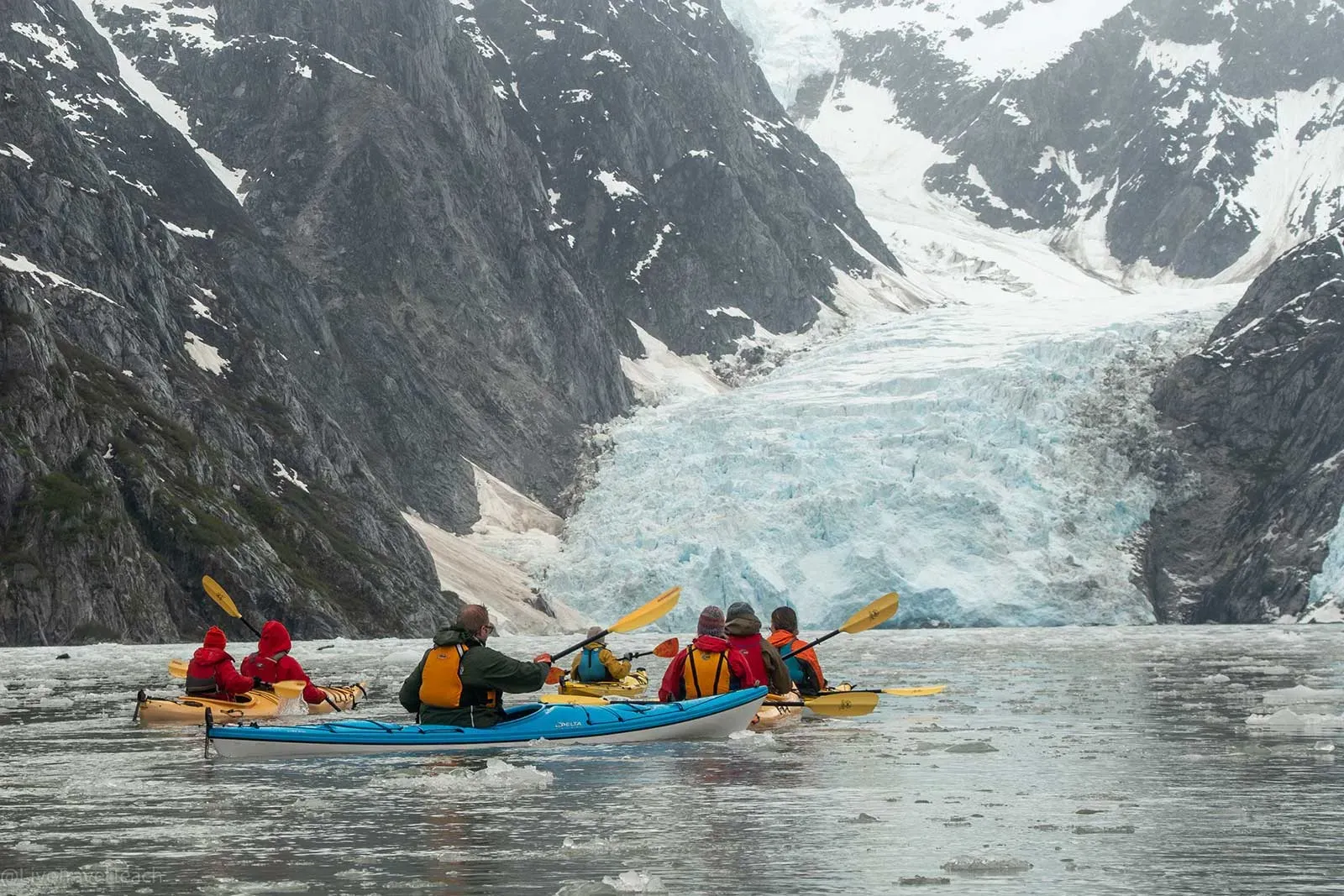 Kayakers near glacier in Kenai Fjords Alaska