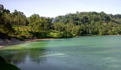 Lake Linow's multi-colored waters with wooden boardwalk and viewing platform
