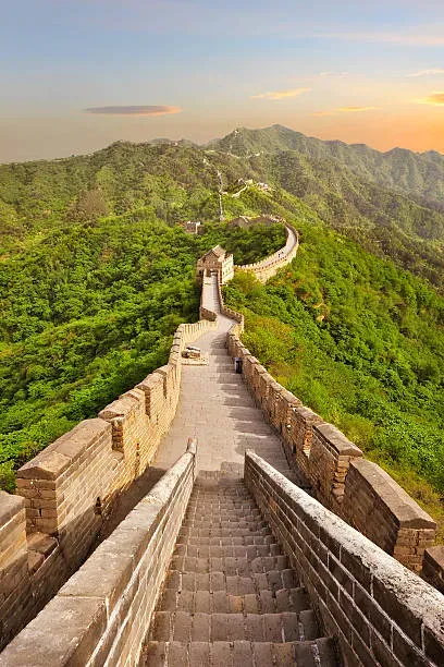 Panoramic sunset view of the Great Wall winding along mountain ridges