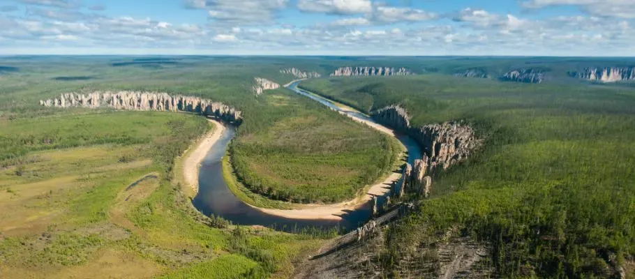 Meandering Lena River winding past the pillars with lush forest