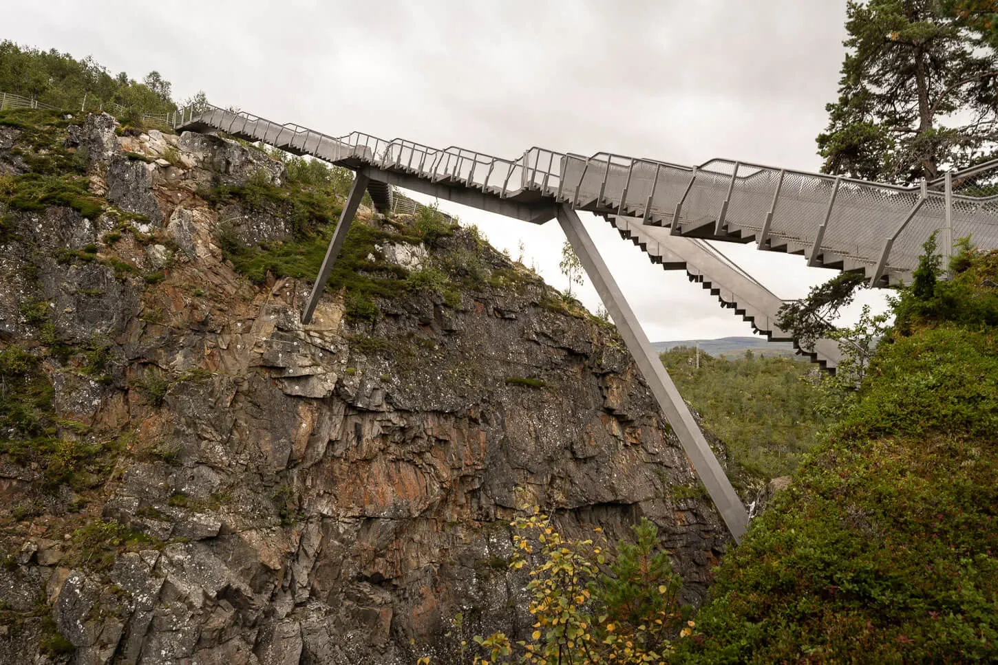 Modern architectural pedestrian bridge spanning canyon above Vøringsfossen