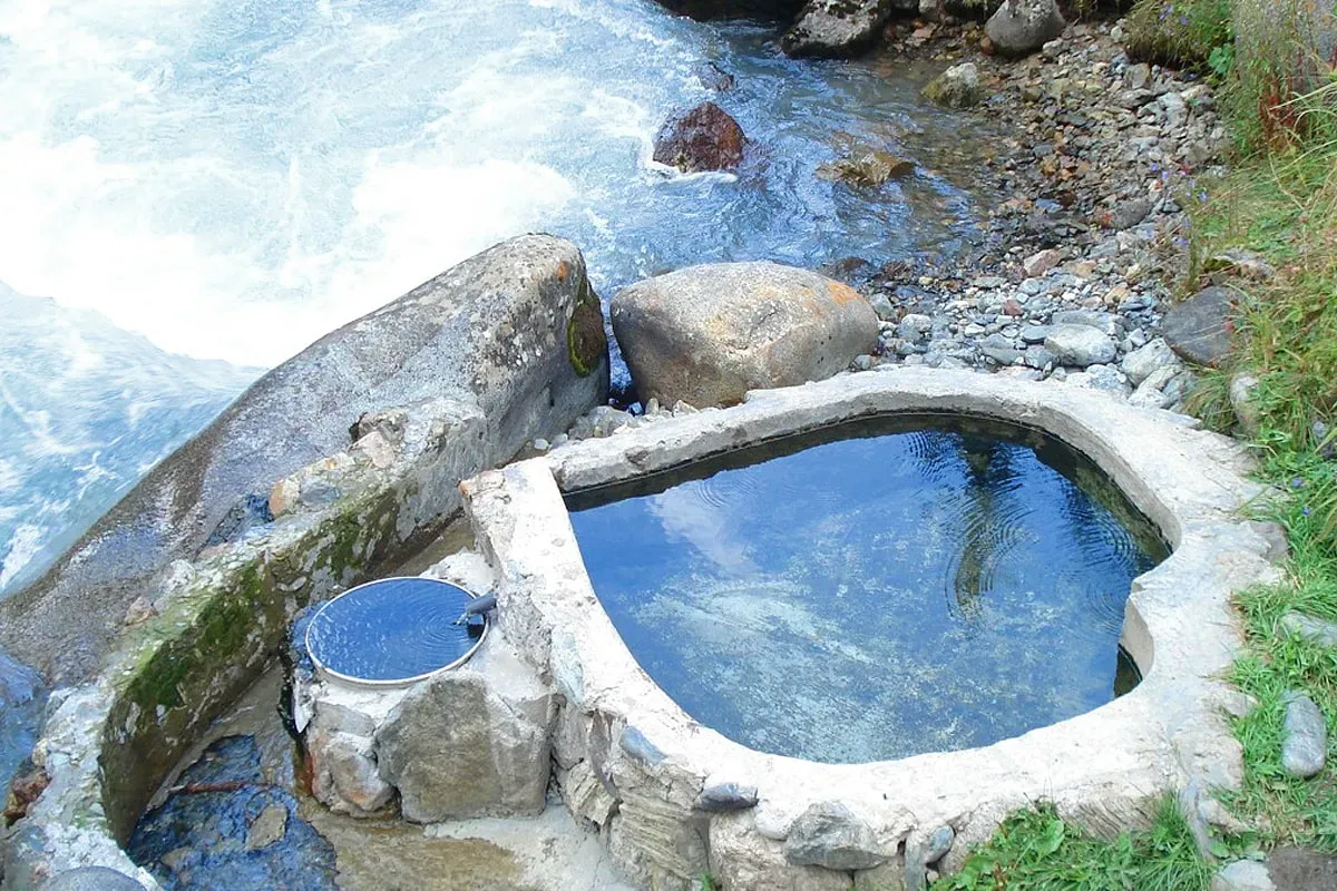 Natural hot spring pool with turquoise mineral water