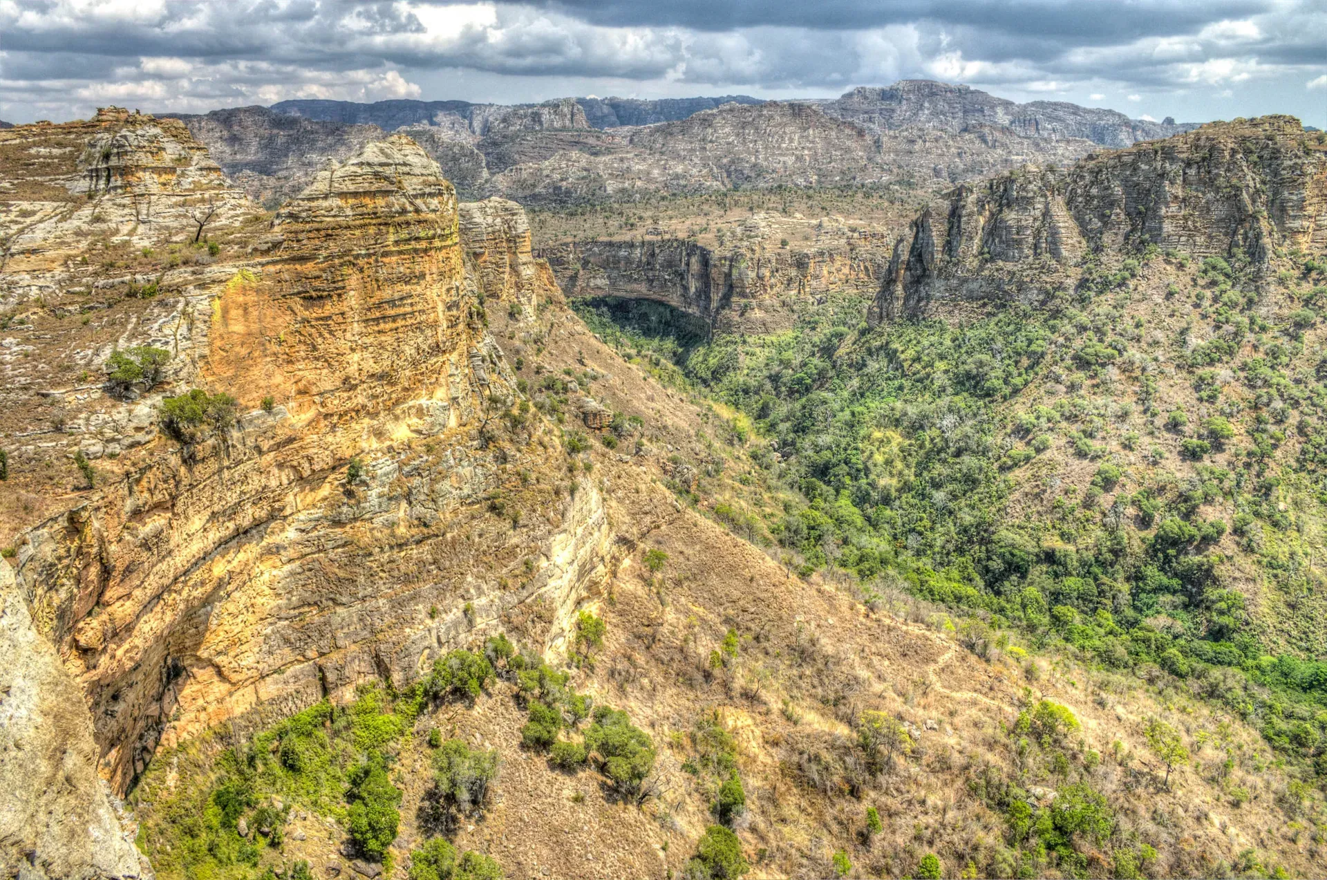 Rugged sandstone canyon walls with layered rock formations in Isalo National Park