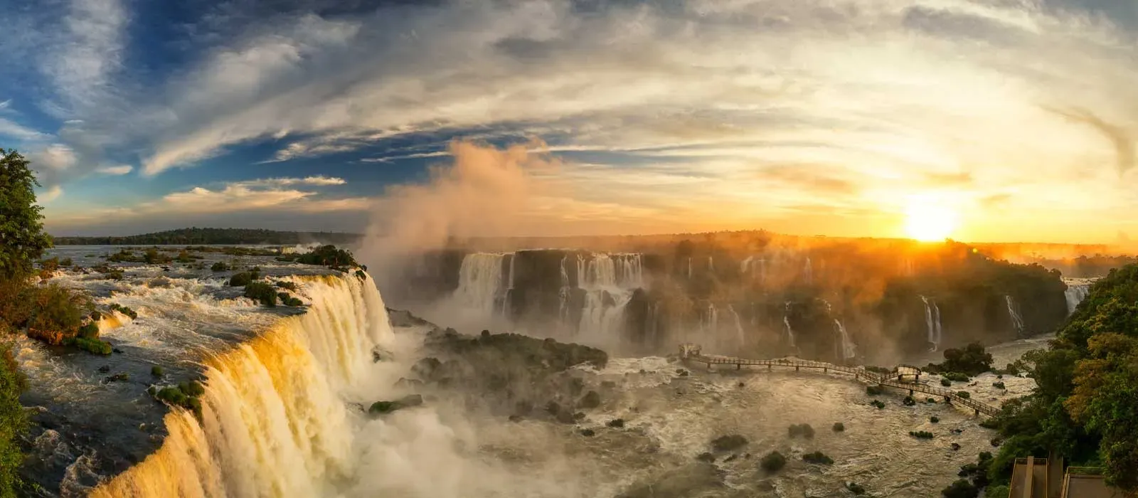 Sunset view of Iguazu Falls Argentina with golden light illuminating the cascading waterfalls