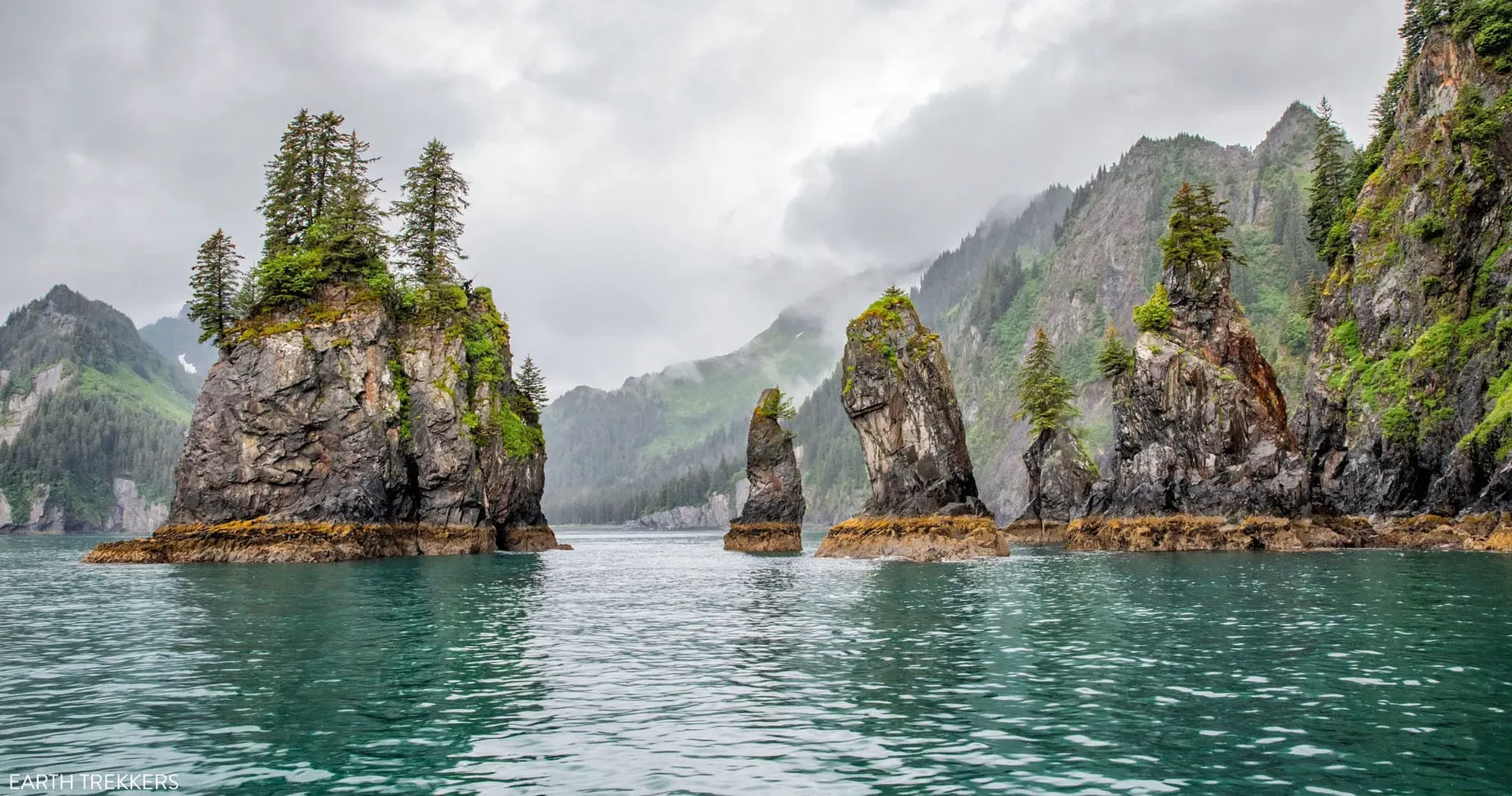 Sea stacks rising from turquoise waters in Kenai Fjords Alaska