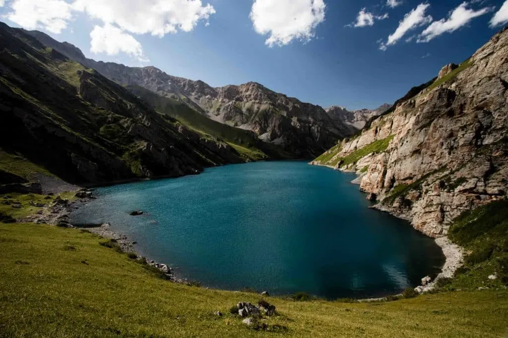 Kol Tor Lake surrounded by steep rocky mountain slopes