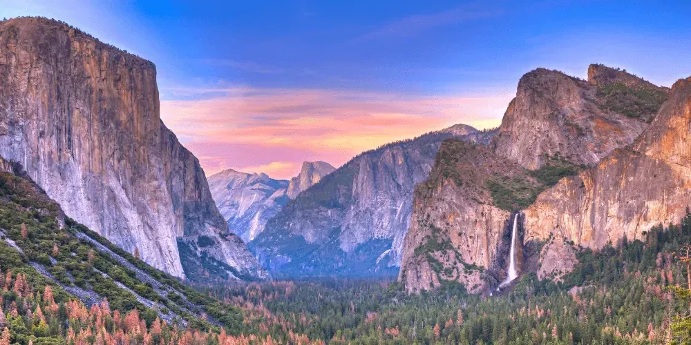 Yosemite National Park United States valley at sunset with sunlight streaming through mountains