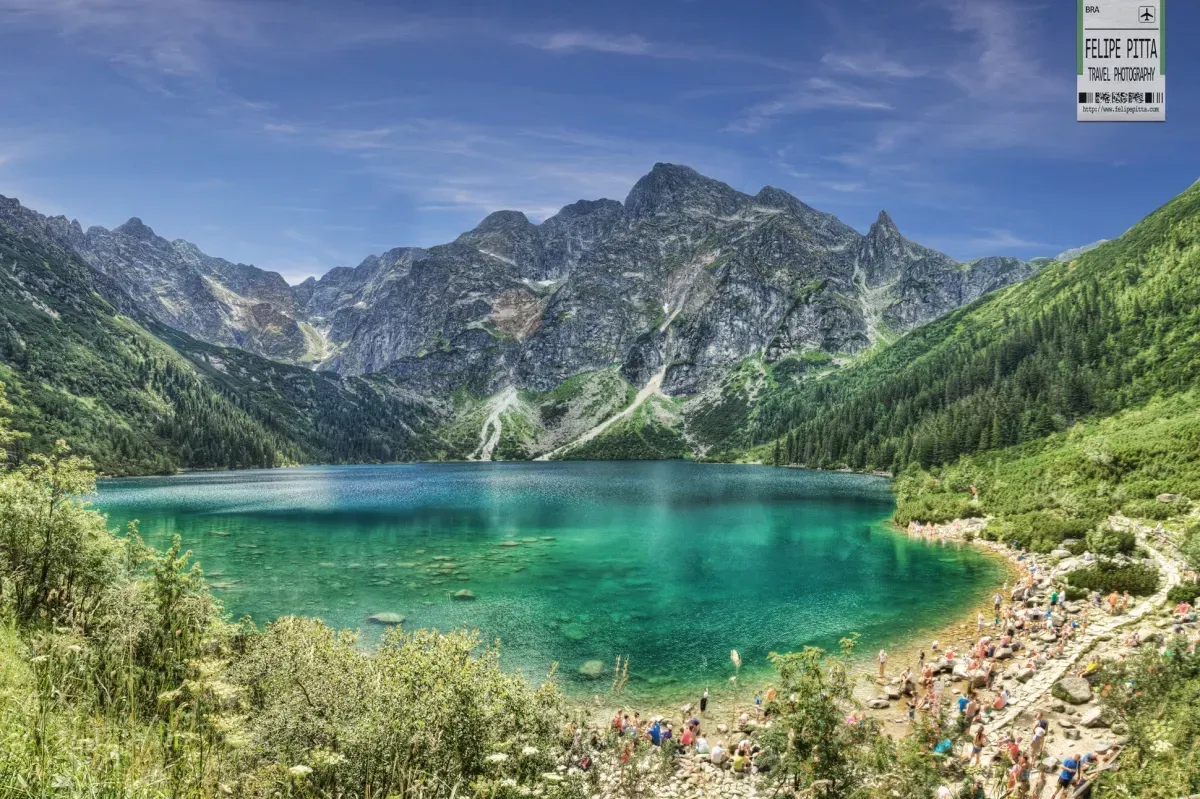 Artistic landscape photograph of Morskie Oko in the Tatra Mountains with calm water reflecting the mountain peaks