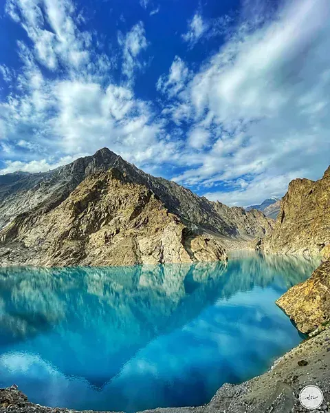 Attabad Lake Pakistan reflecting Karakoram mountain peaks in crystal-clear turquoise water