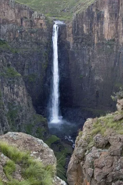 Boalathapo Falls seen from Phororo viewpoint showing the waterfall dropping into the canyon with rolling hills beyond in Lesotho