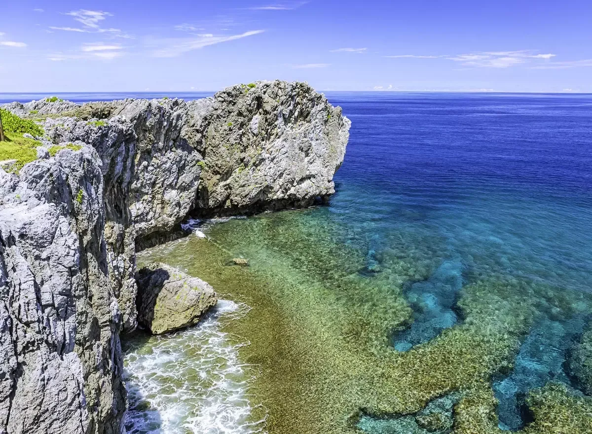 Cape Hedo rugged coastline with dramatic sea cliffs and turquoise waters at the northern tip of Okinawa in Yanbaru National Park