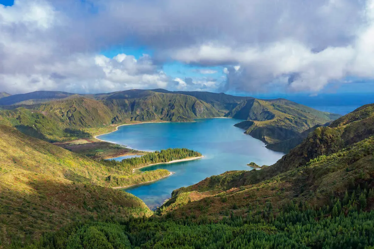 Crater lake Lagoa do Fogo on São Miguel Island, Azores, Portugal, with emerald green vegetation and brilliant blue water