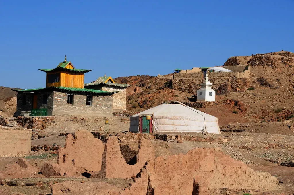 Crumbling stone and wooden monastery walls at Ongi Monastery in the arid Gobi landscape