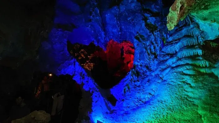 Multicolored lighting illuminating stalactites and stalagmites inside Grutas de Nombre de Dios Chihuahua