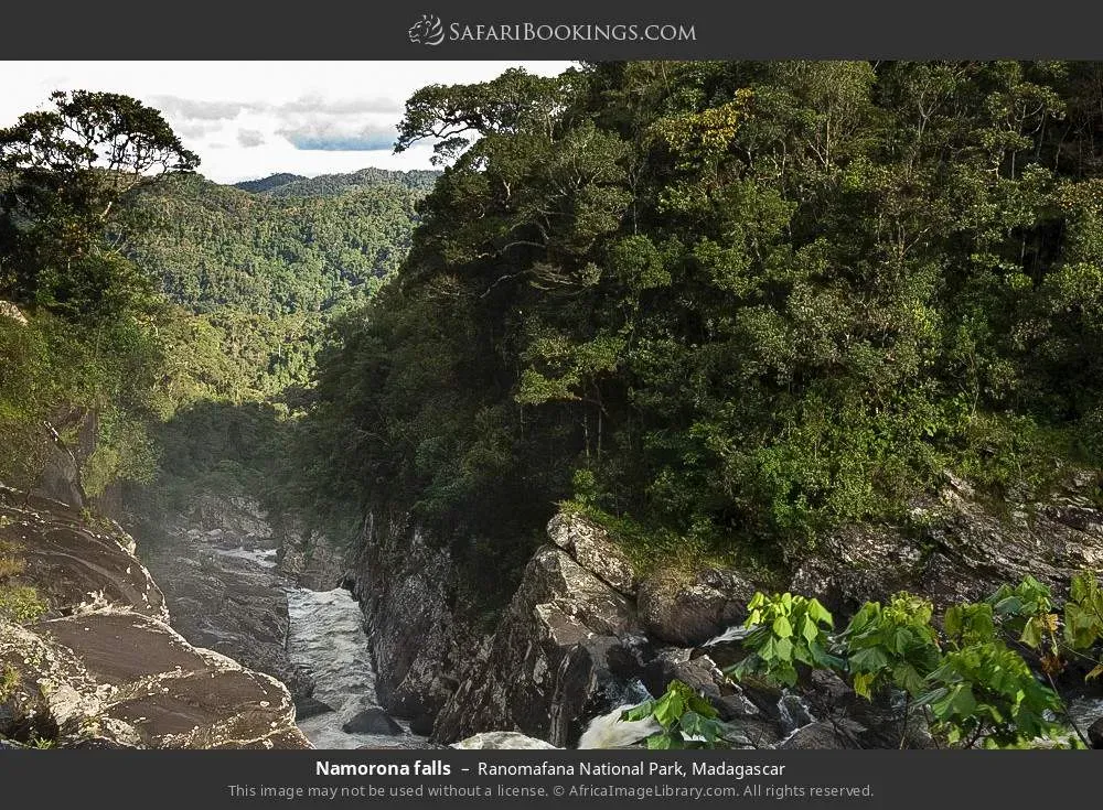 Namorona Waterfall cascading down rocky cliffs surrounded by lush rainforest in Ranomafana National Park Madagascar