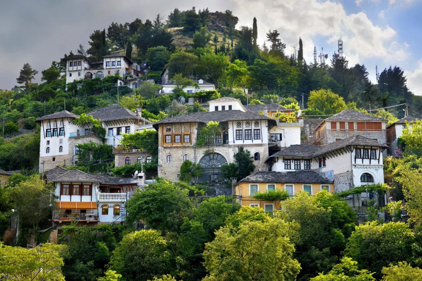 Traditional Ottoman stone houses climbing the hillside below Gjirokastra Castle Albania