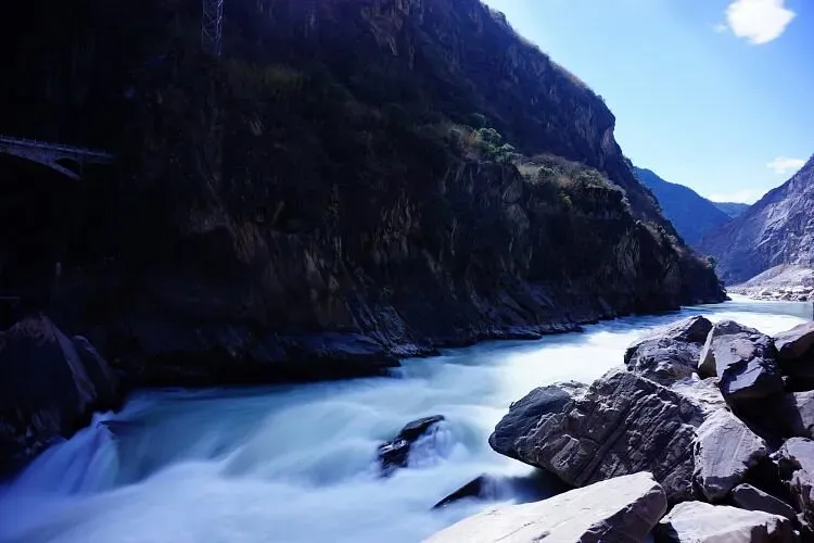 Rushing turquoise Jinsha River flowing through narrow rocky canyon in Tiger Leaping Gorge China