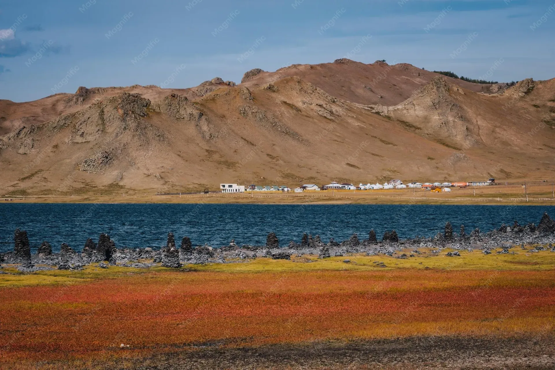Traditional Mongolian ger camp with mountains in the background at Terkhiin Tsagaan Lake