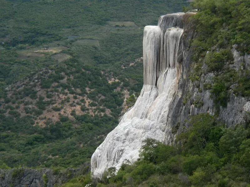Massive petrified waterfall at Hierve el Agua Oaxaca Mexico with calcified mineral deposits cascading down the mountainside