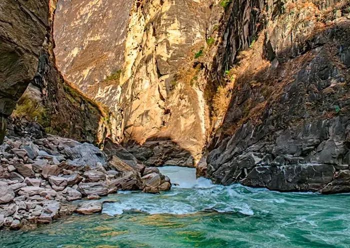 Turquoise river meandering through narrow rugged canyon in Tiger Leaping Gorge China