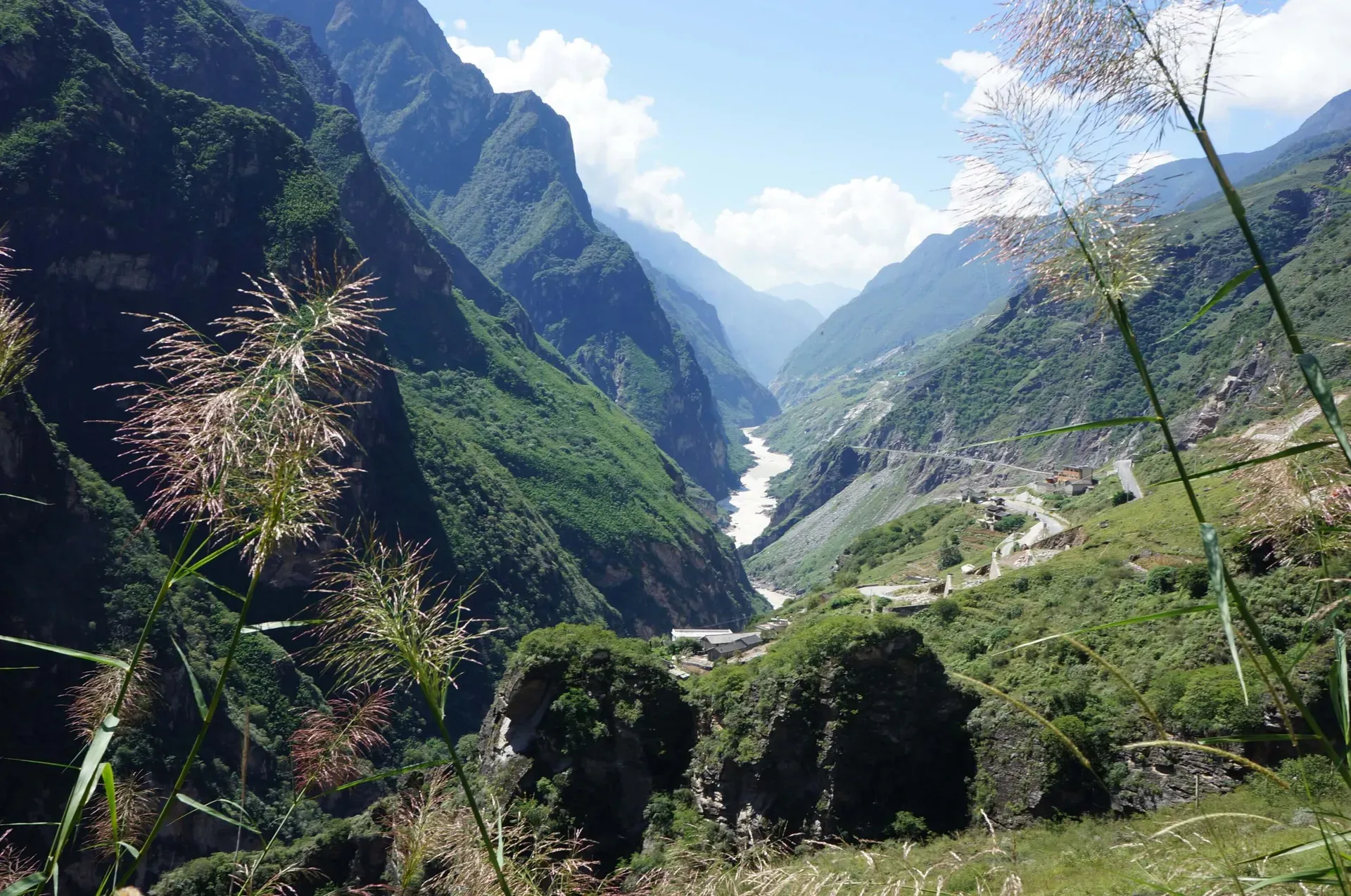 Vivid green mountains surrounding deep valley with Jinsha River in Tiger Leaping Gorge China