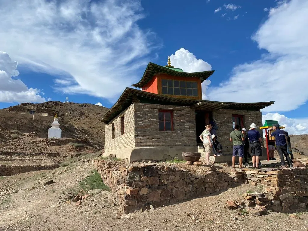 White Buddhist stupa among Ongi Monastery Mongolia ruins with Gobi Desert hills in the background