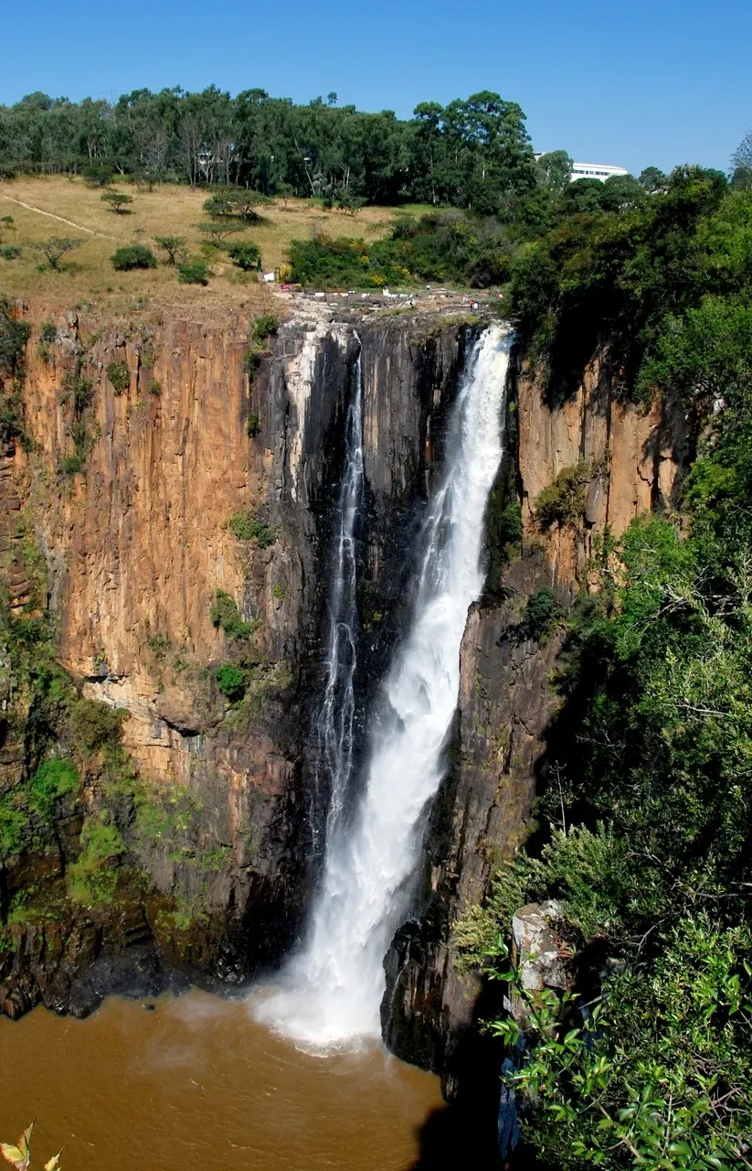 Howick Falls South Africa under clear blue sky with the 95-metre single drop cascading over sheer rock cliff