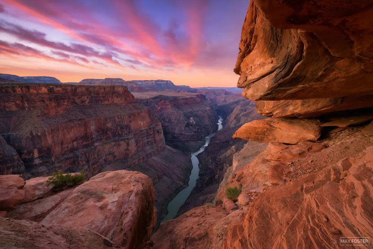 Sunset view of Grand Canyon Arizona with pink and orange skies over layered rock formations