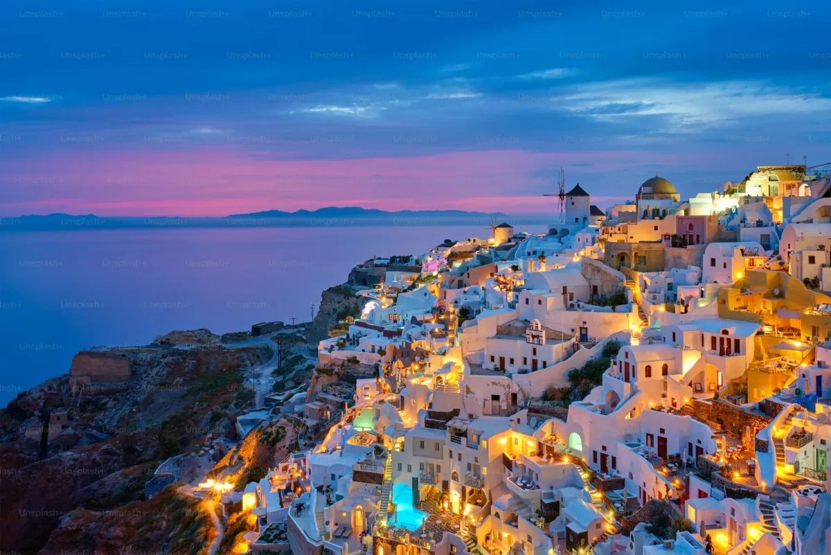 Famous Oia village with traditional white houses and blue domed churches on the caldera