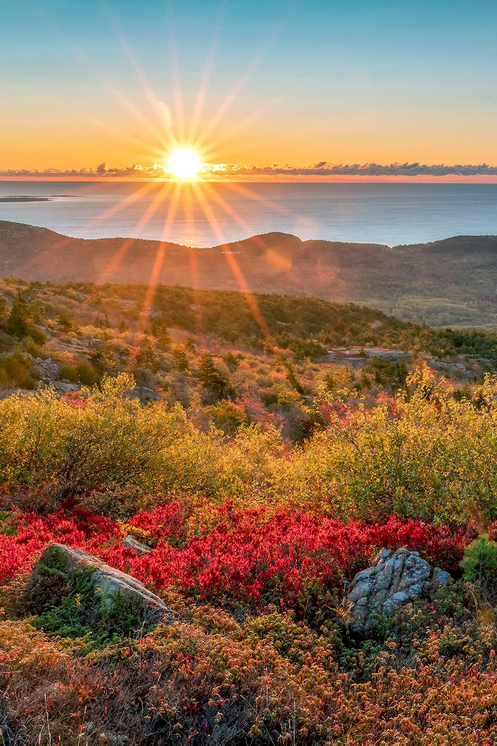 Sunrise over Cadillac Mountain in Acadia National Park United States with colorful autumn foliage