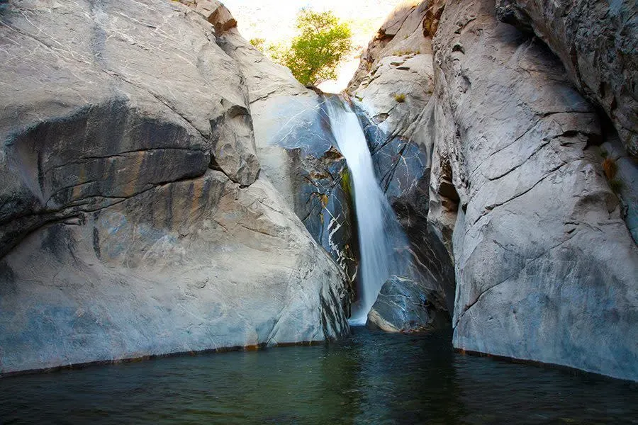 Tahquitz Falls, a 60-foot seasonal waterfall spilling into a deep pool in Tahquitz Canyon, Palm Springs