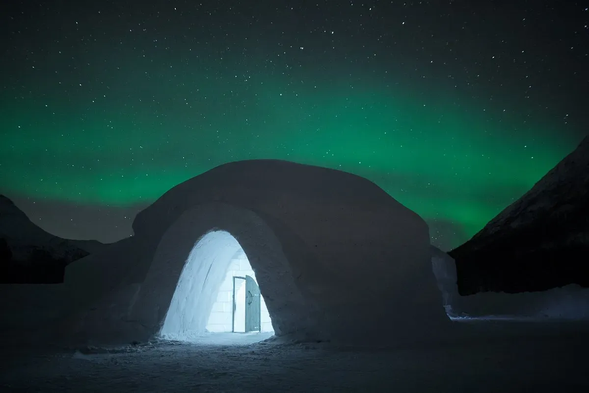 Tromsø Ice Domes glowing under Northern Lights in Tamokdalen Norway