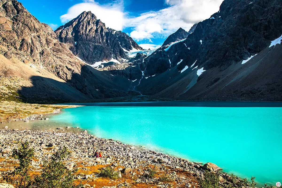 Turquoise glacial lake Blåisvatnet Norway surrounded by snow-capped mountains in the Lyngen Alps